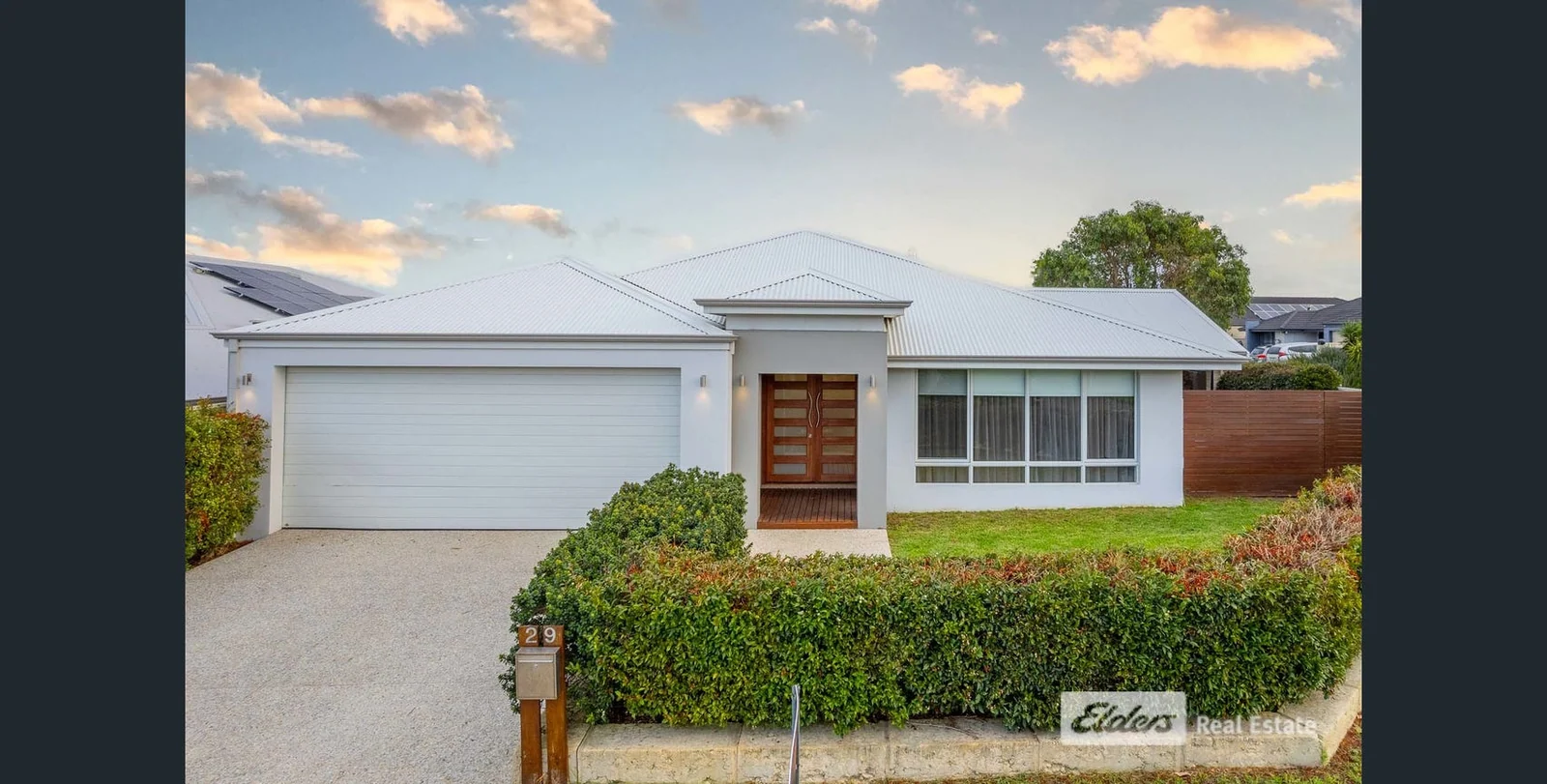 A contemporary home with a broad frontage and simple landscaping.