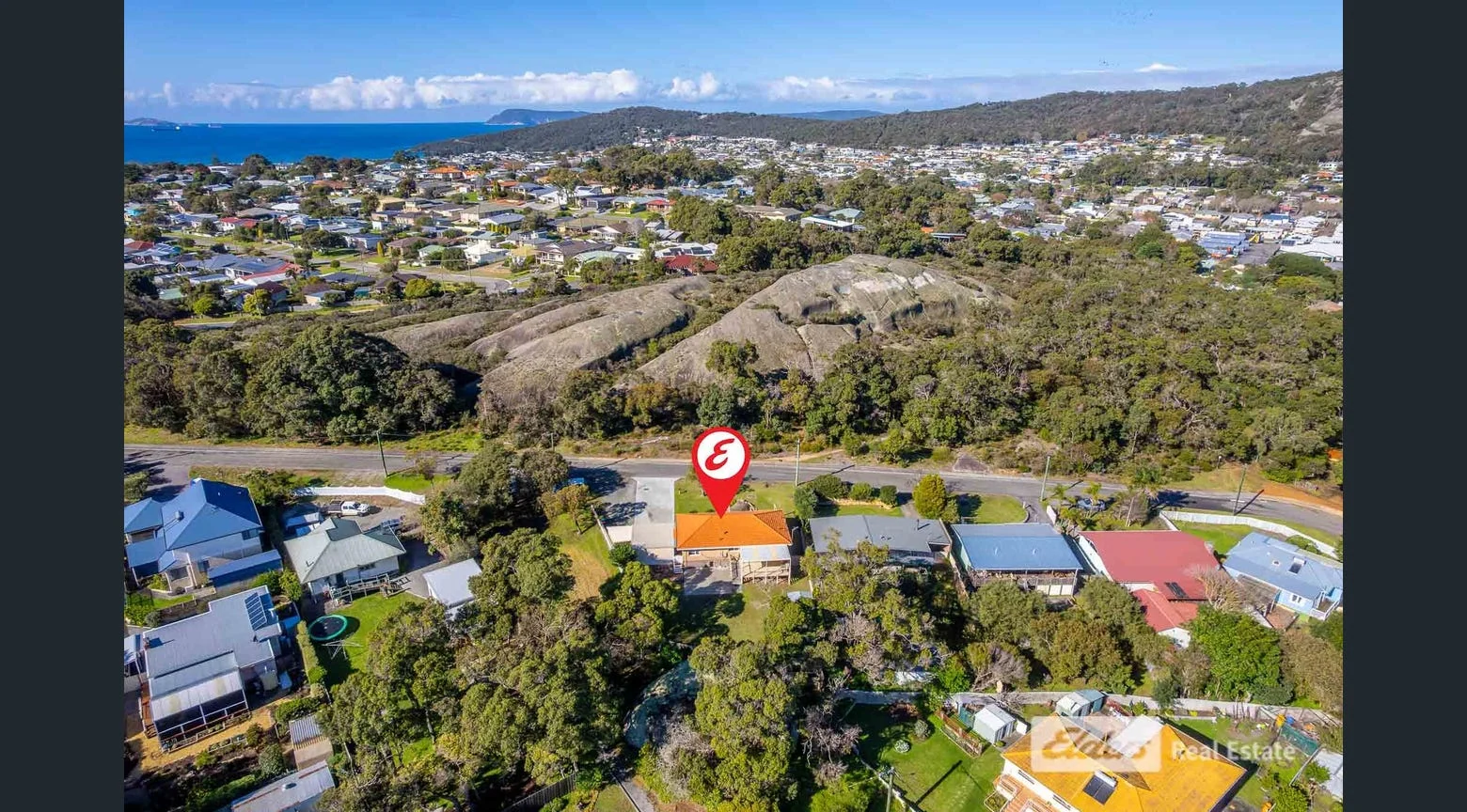 A residential neighbourhood seen from above, with homes, trees and streets.